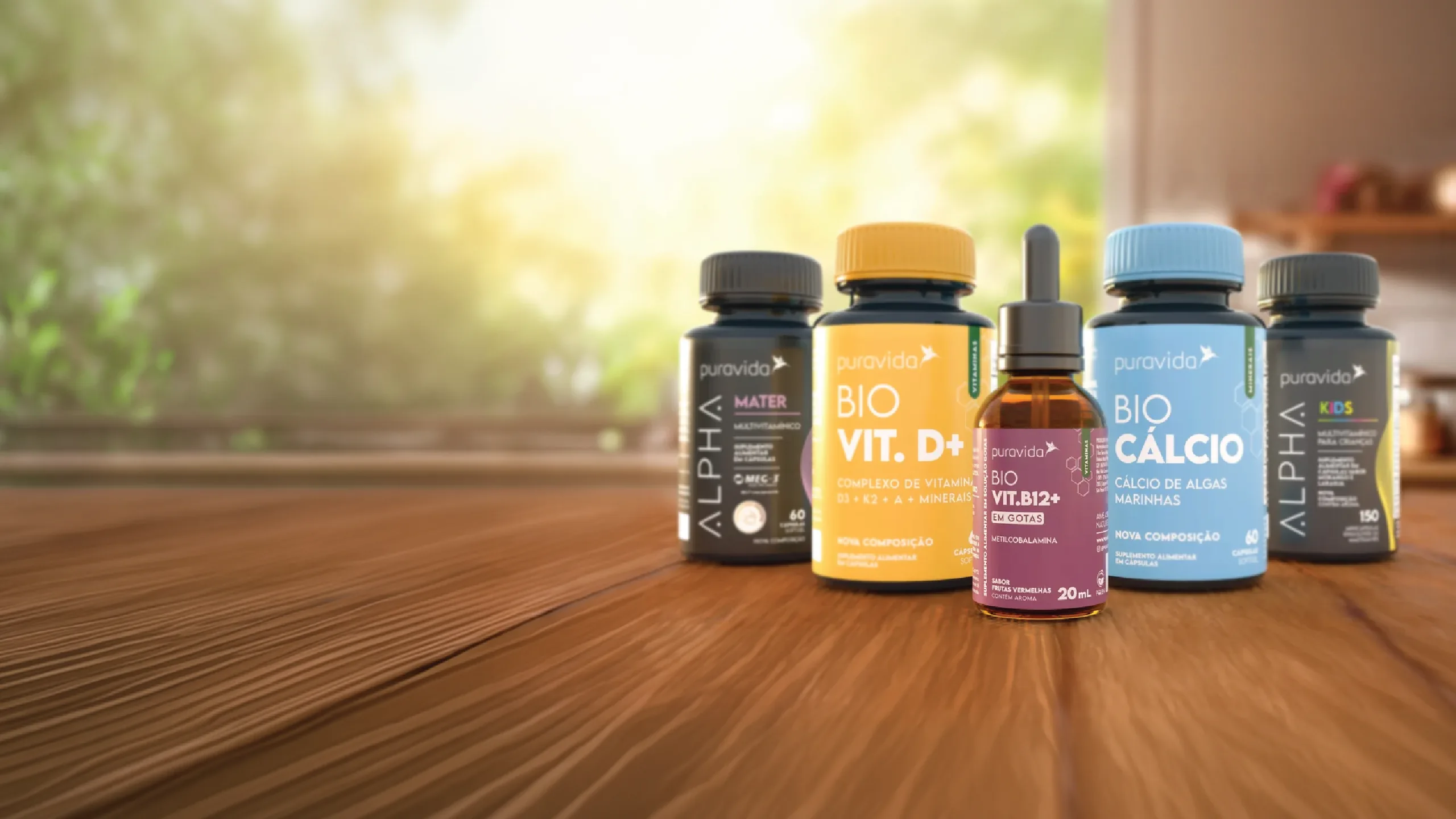 Five products from the Nestlé Puravida supplement line on a wooden worktop: the Alpha family in black and the Bio family in yellow, blue and burgundy.